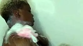 Young ebony babe enjoys a relaxing bath time massage with sensual touches.