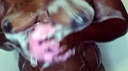 Young ebony babe enjoys a relaxing bath time massage with sensual touches.