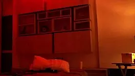 Linda Houston dances seductively under the full red light, captivating everyone with her moves