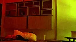 Linda Houston dances seductively under the full red light, captivating everyone with her moves