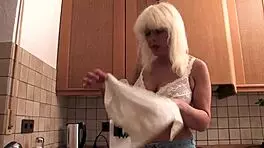 this little slut undresses while cooking, teasing her big cock in the kitchen