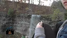blonde gives outdoor blowjob at waterfall, almost caught