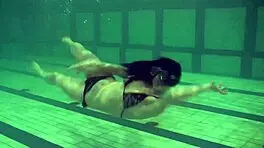 brunette teen kristina andreeva enjoys a naked swim in the pool, showing off her tight body.