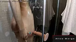 Blonde teen masturbates in shower with dildo