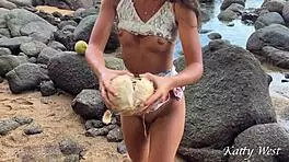 Look at this naked girl pouring coconut juice all over herself on a public beach!