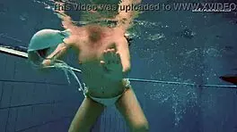 Petite 18+ brunette pornstar Alla swims naked in the hot pool, showing off her horny tits and ass while smoking