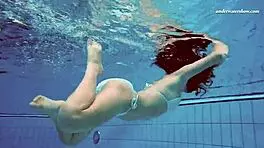 Petite 18+ brunette pornstar Alla swims naked in the hot pool, showing off her horny tits and ass while smoking