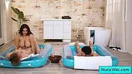 Sexy big beautiful busty masseuse handles two young 18+ boys in steamy nuru massage session.