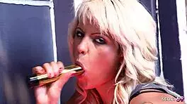 Katie and Scarlett in fishnets, playing lesbian with dildos.