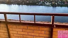 Hey, wanna watch this smoking girl blow fast on a public balcony?