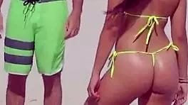 Young girl in micro bikini enjoys beach day with boyfriend's relatives
