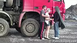 petite blonde hottie gets fucked in a public threesome by two guys at the construction site