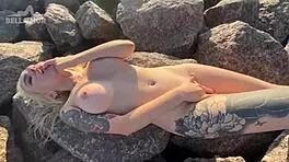 hot exhibitionist teases her clit on a crowded public beach