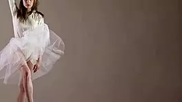 Blonde gymnast just casually showing off moves in a naked workout.