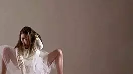 Blonde gymnast just casually showing off moves in a naked workout.