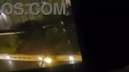 Milf masturbates in front of hotel window.