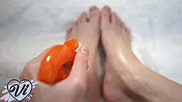 Brunette Shows Her Tattooed, Oiled Feet in Fetish Close-Up.