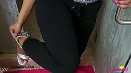 Stunning bronze skin model taking a shower in photoshoot