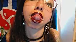 young goth applies dark red lipstick and teases huge puffy nipples