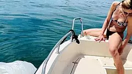 blonde housewife washes boat in sexy thong swimsuit for summer fun.