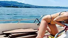blonde housewife washes boat in sexy thong swimsuit for summer fun.