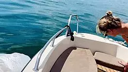 blonde housewife washes boat in sexy thong swimsuit for summer fun.