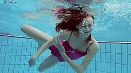 Anna netrebko teases in bikini while swimming in the pool, showing off her petite figure.