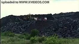 A young blonde cutie gets fucked hard in the street by two guys in a public threesome