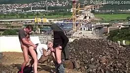 A young blonde cutie gets fucked hard in the street by two guys in a public threesome