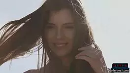 Petite Russian centerfold Kate Chromia strips outdoors, ripping clothes to reveal hairy pussy and tits.