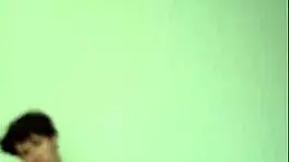 On a sunny day, this horny young teen masturbates with a big cock on the bed, getting cum covered.