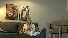 Busty milf casually strips panties on couch while reading
