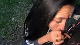 Brunette teen girlfriend gives wet sloppy blowjob with cum in mouth to big cock friend in evening park outdoors