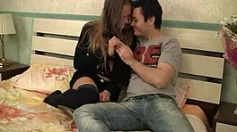 Fragile teen reveals tight pink pussy for camera, contrasting innocence with hardcore desires.