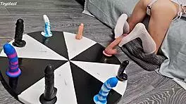 Petite girl wins orgasm playing wheel of dildos