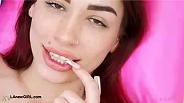 Red-haired model casually reveals her sexy body on sofa.