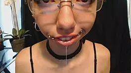 Goth Girl Applies Lipstick and Drools Playfully