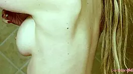 charming blonde girl enjoys a hot shower