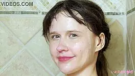 charming blonde girl enjoys a hot shower