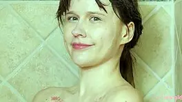 charming blonde girl enjoys a hot shower