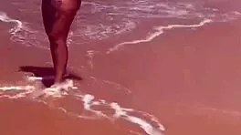 Young African Woman Flashes On The Beach