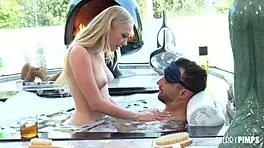 petite blonde girl braylin bailey relaxes in hot tub