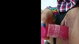 opening her pussy and inserting a pink dildo she shows her wet pussy