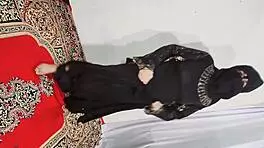 Arabic beauty in black hijab sways hips and bounces curves to exotic beats