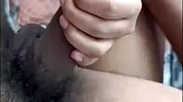 desi hottie strokes cock with feet while buzzing on bed