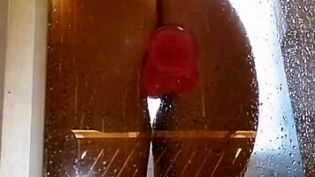 Appetizing ass girl spreads wide for pink toy fun in steamy shower.